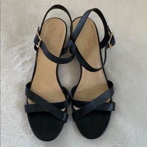 Black strapped wedged heels by Cole Haan
